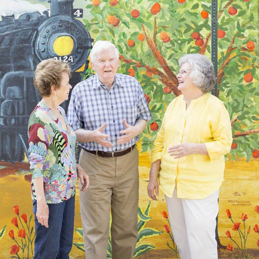 Hillcrest | Happy seniors in front of mural