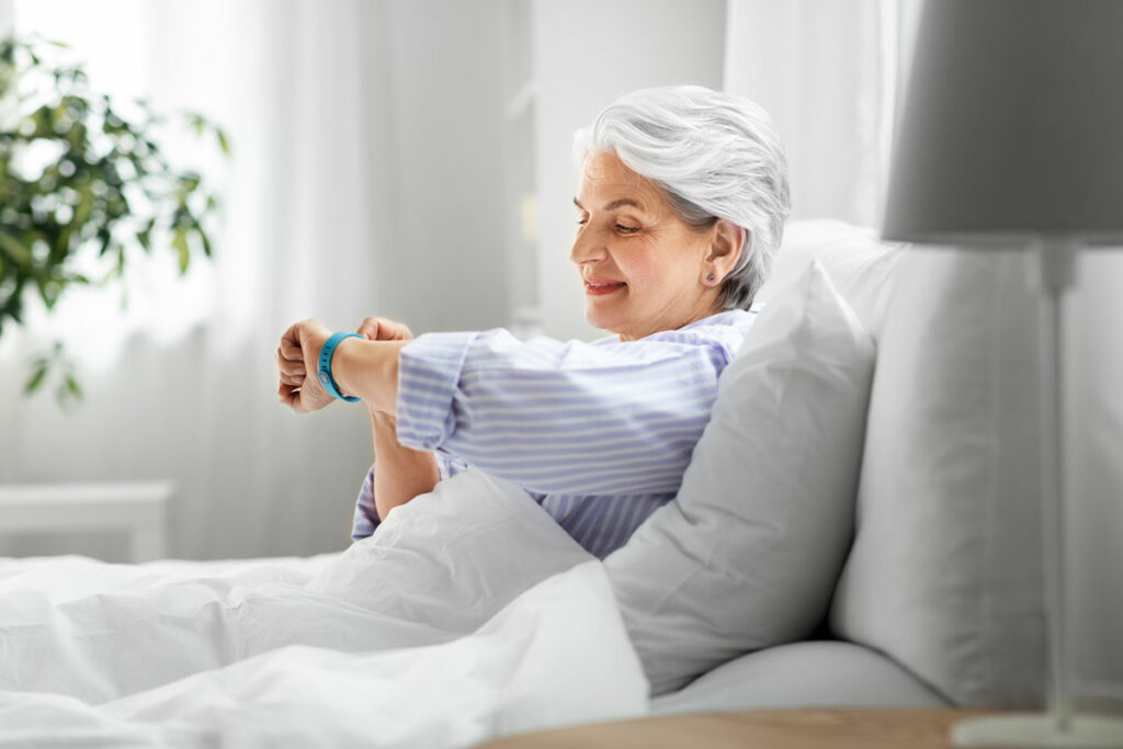 Hillcrest | Senior woman checking watch in bed