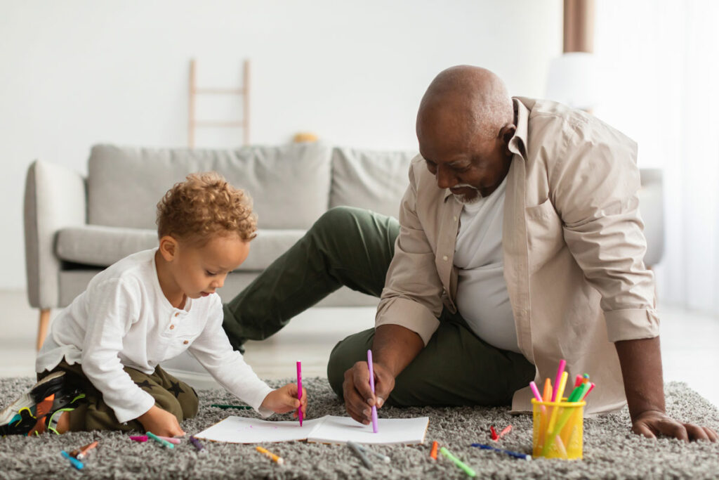 Hillcrest | Senior man drawing with grandson