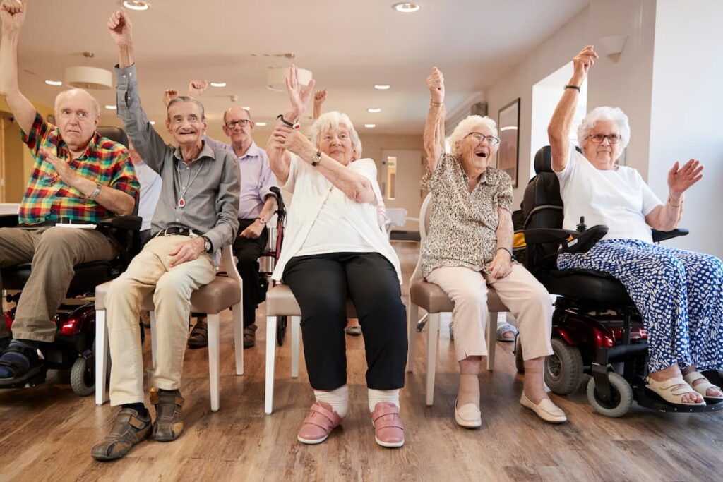 Hillcrest | Group of seniors doing chair exercises together - dementia care in Los Angeles