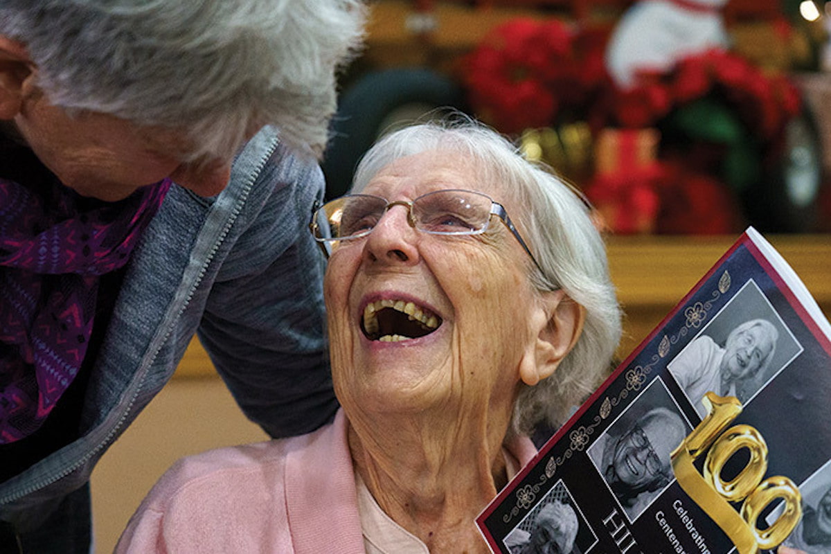 Hillcrest | Centenarian smiling during an event recognized