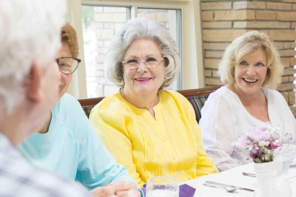 Hillcrest | Senior women socializing at table Hillcrest | Senior women socializing at table